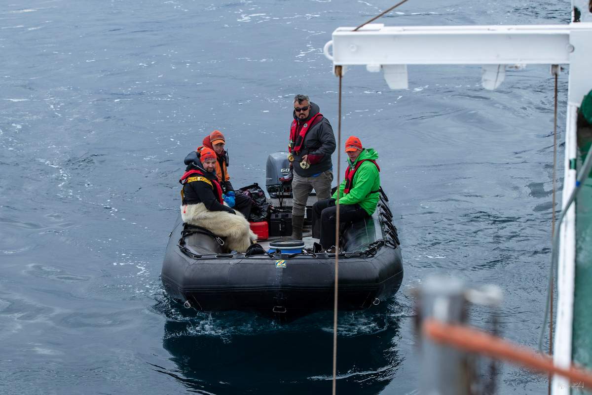 Matthew Ayre, Michael Moloney, One Ocean crewmembers Ted Irniq and Kelson Rounds-McPherson aboard a dingy in search of shipwreck.