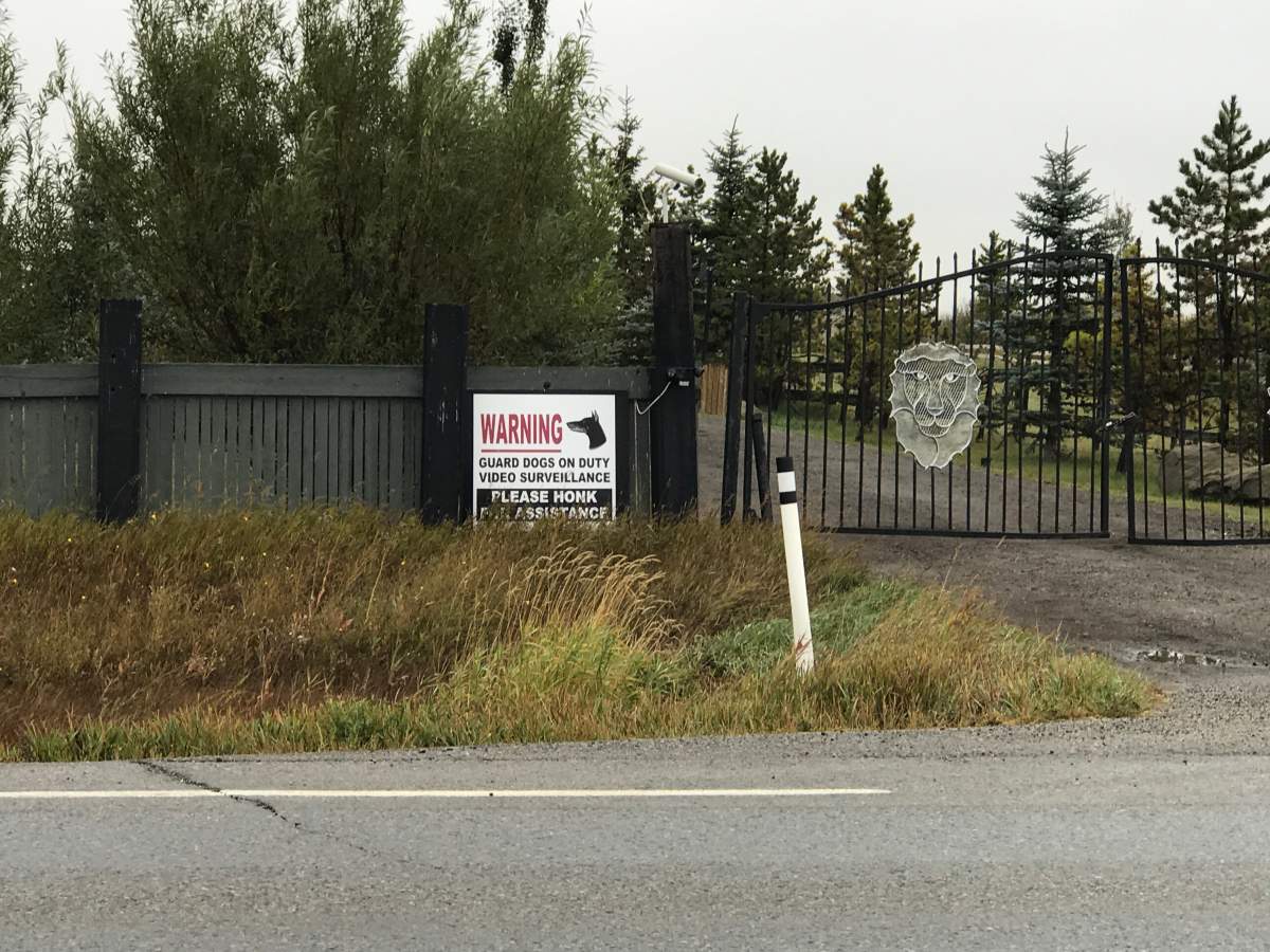 A sign warns visitors outside the home where two people were attacked by a dog Saturday night.