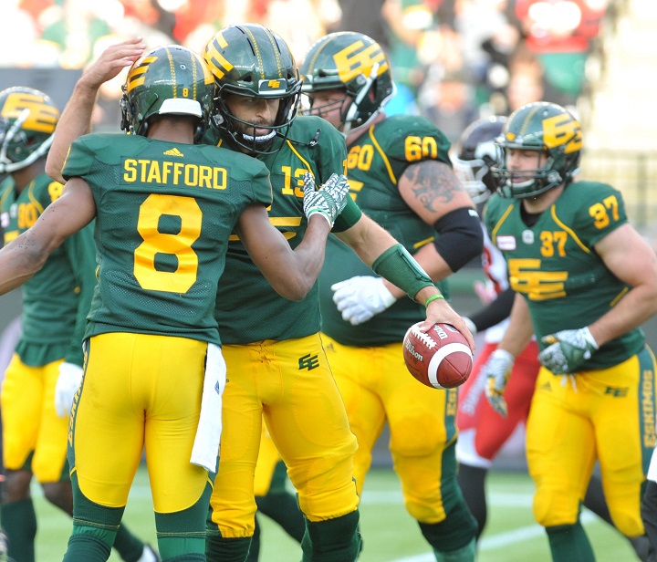 Edmonton Eskimos player #13 (QB) Mike Reilly celebrates a touchdown with Eskimos player #8 (WR) Kenny Stafford during the 2nd  quarter of CFL game action between the Edmonton Eskimo's and the Calgary Stampeders at the Brick Field located at Commonwealth stadium in Edmonton Saturday, September 8, 2018.