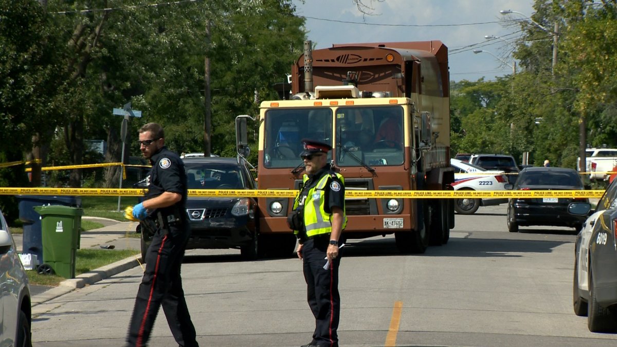 A man is in critical condition after police say he was pinned between a SUV and a garbage truck.