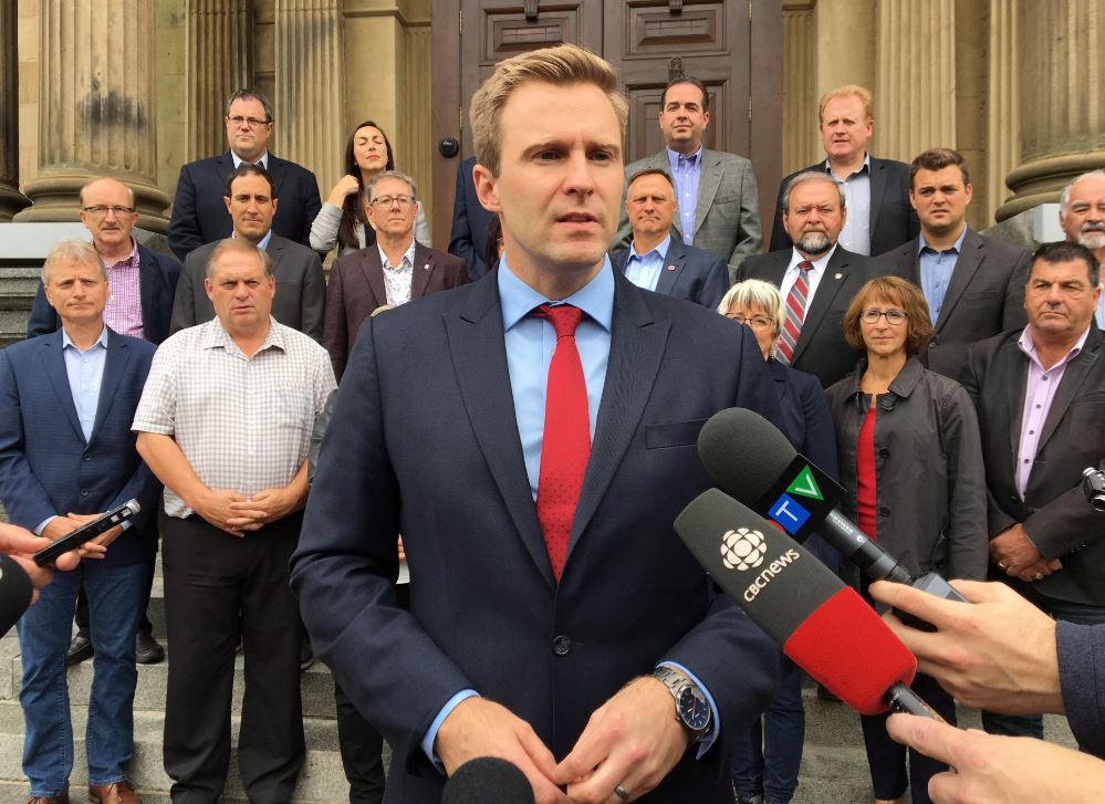 New Brunswick Premier Brian Gallant speaks to reporters in front of the provincial legislature in Fredericton on Wednesday, September 26, 2018. 