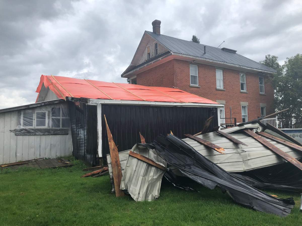 A pile of debris is piled outside the Anderson family’s destroyed garage in Kinburn, a rural community in west Ottawa. The owners of Kinburn Farms are “extremely overwhelmed” with the challenges facing them after Friday’s tornado.