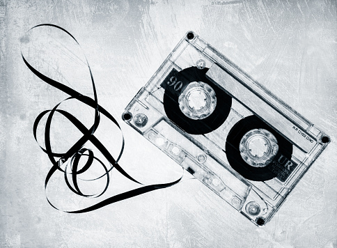 Grungy old cassette tape in black and white.