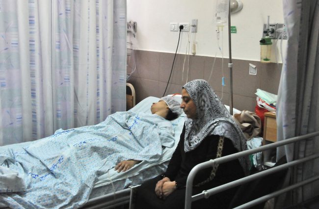 In this July 27, 2014 file photo, a heavily injured patient lies on a bed in Makassed Hospital in East Jerusalem. 


