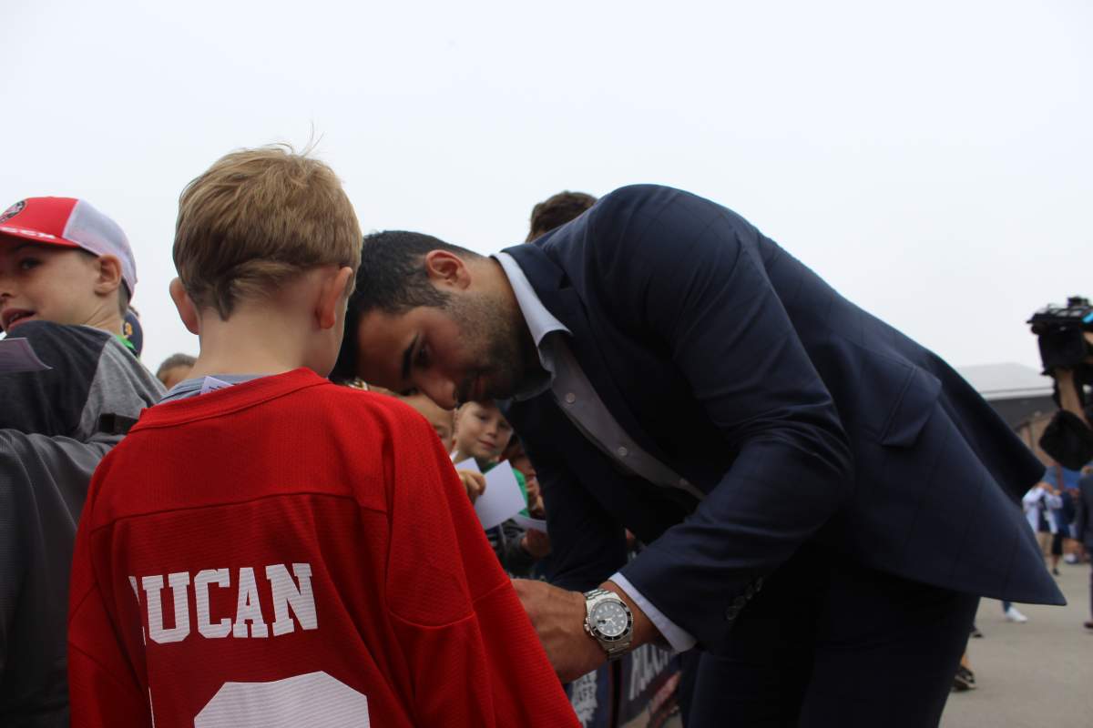 Blake Burgess gets his shirt signed by Toronto Maple Leaf, and former London Knight, Nazem Kadri.