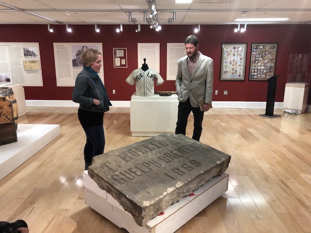 Guelph Civic Museum curator Dawn Owen and guest curator Eric Payseur show off the centrepiece of their new exhibit, "Brewing Changes Guelph.".