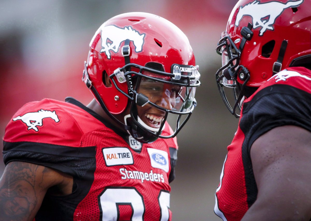 Calgary Stampeders' Kamar Jorden, left, celebrates his touchdown with a teammate during first quarter CFL football action against the Montreal Alouettes, in Calgary, Saturday, July 21, 2018. Jorden is out for the year and is facing knee surgery. 