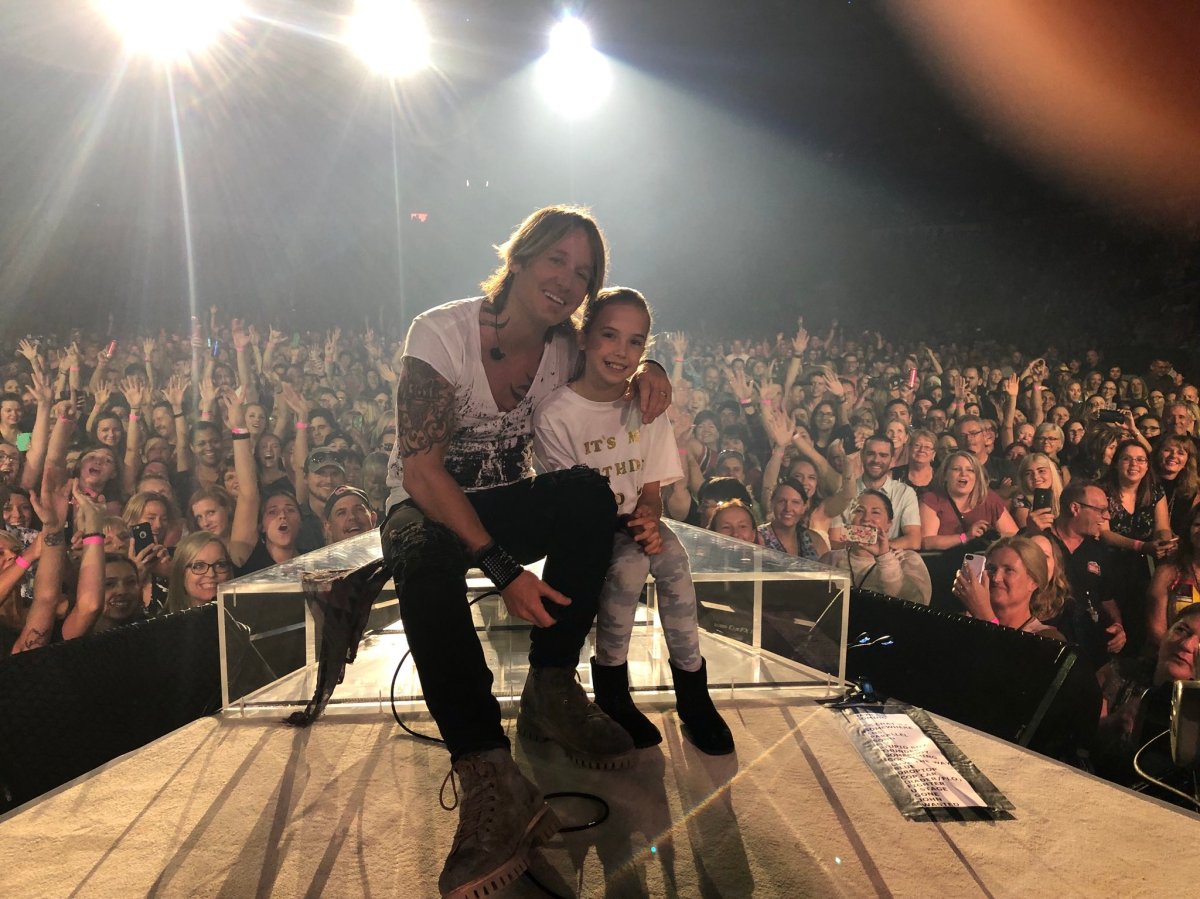 Keith Urban poses on-stage with 10-year-old Ella, who celebrated her 10th birthday during Urban's show on Saturday.