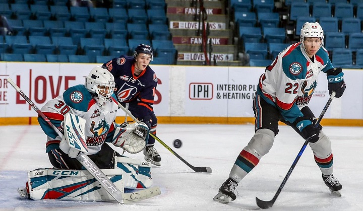 Kelowna Rockets defenceman Braydyn Chizen, right, looks back while goaltender Roman Basran focuses on the puck. Lurking near the crease is Orrin Centazzo of the Kamloops Blazers.