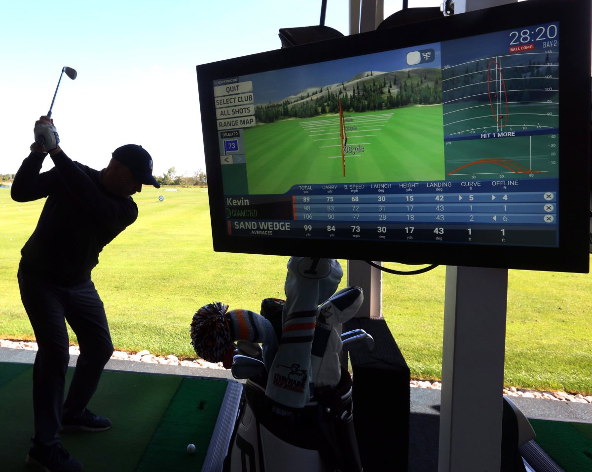 Kevin Haime owner of the Kevin Haime Golf Centre swings his golf club to demonstrate Topgolf technology, in Kanata, Ont. on Friday, September 7, 2018.