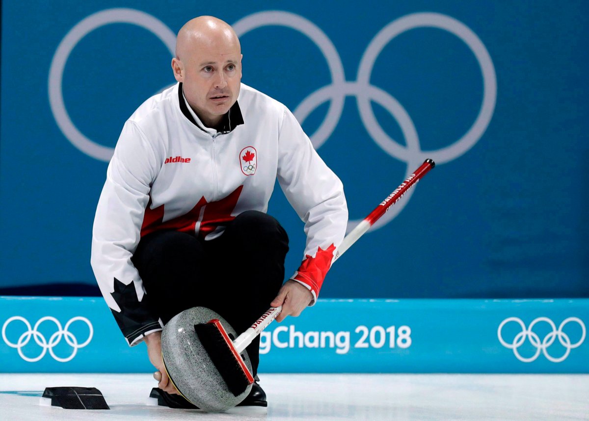 FILE: Canada's skip Kevin Koe uses his broom to clean the stone during the men's curling match against Switzerland at the 2018 Winter Olympics in Gangneung, South Korea on Feb. 23, 2018. 