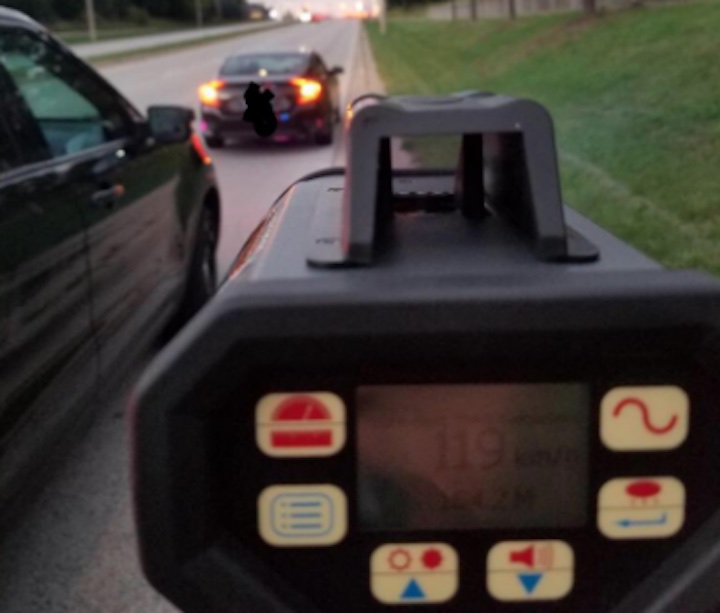 Police tweeted out an image of a detector device showing a reading of 119 km/h as a vehicle is pulled over at the side of the road.