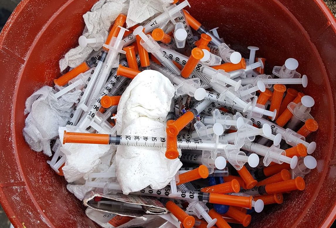 Buckets of needles found behind a home on Mountain Avenue.