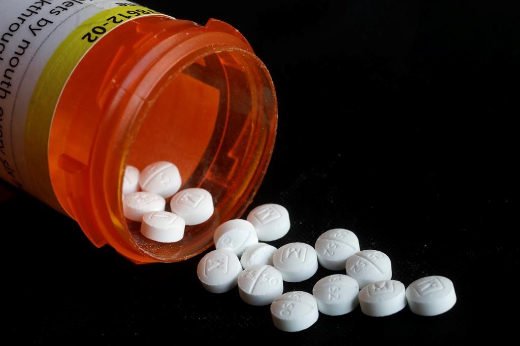 This Aug. 29, 2018 photo shows an arrangement of prescription Oxycodone pills in New York. Figures from a 2017 survey released on Friday, Sept. 14, 2018, show fewer people used heroin for the first time compared to the previous year, and fewer Americans misusing or addicted to prescription opioid painkillers. (AP Photo/Mark Lennihan).