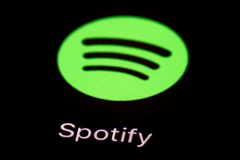 FILE- This March 20, 2018, file photo shows the Spotify app on an iPad in Baltimore. A former sales executive is suing Spotify for gender discrimination and equal pay violations, saying executives organized ‚Äúboys‚Äô trips‚Äù that excluded women and that it paid men more for the same work. (AP Photo/Patrick Semansky, File).