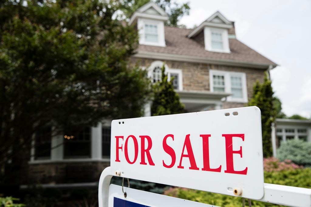 FILE- In this June 8, 2018, file photo a for sale sign stands in front of a house, in Jenkintown, Pa. On Thursday, Sept. 20,.