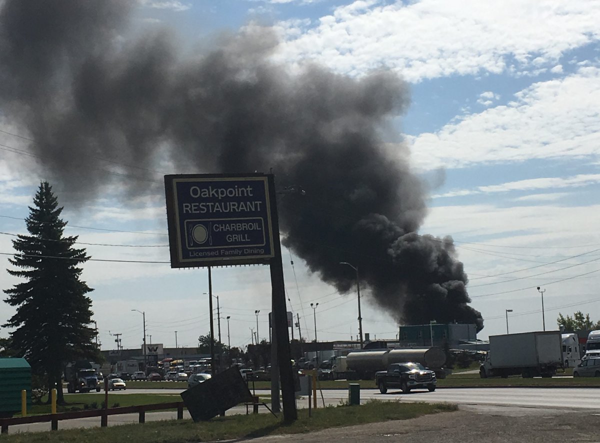 Fire at vehicle compound in Winnipeg sends black smoke into sky - image