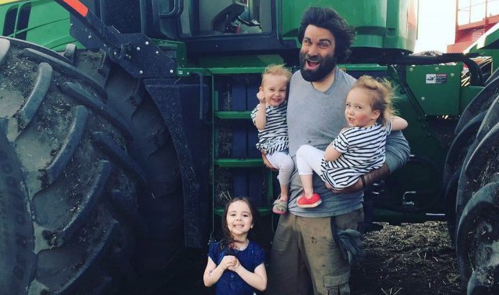 Organic farmer Travis Heide poses with his daughters, left to right, Adora, 9, and twins Audrey, and Gia, 6, near Melfort, Sask., in this undated handout photo.