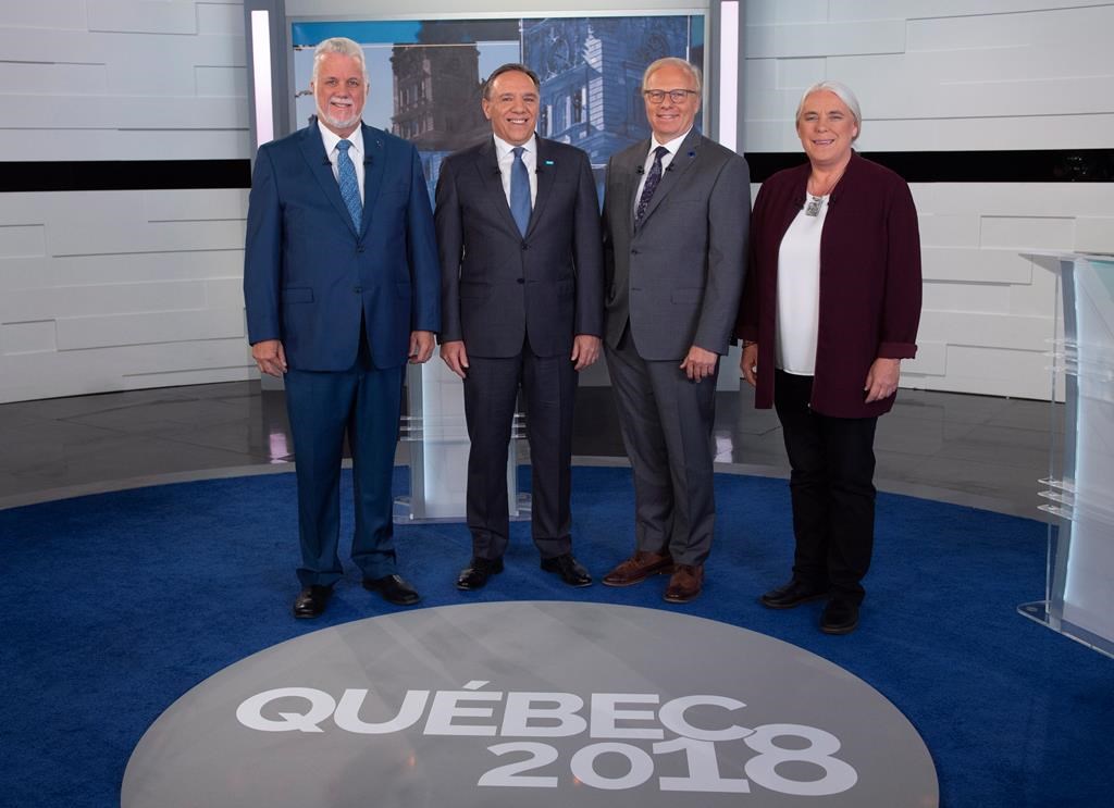 Liberal Leader Philippe Couillard, Coalition Avenir Quebec Leader Francois Legault, PQ Leader Jean-Francois Lisee and Quebec Solidaire Leader Manon Masse, left to right, stand for a photo prior to Face a Face Quebec 2018, the third Quebec elections leaders debate in Montreal, on Thursday, Sept. 20, 2018.