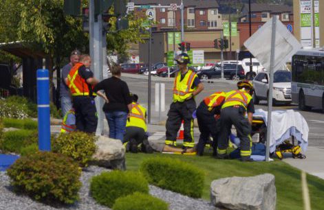 Emergency crews assist cyclist after he was struck by vehicle on Thursday afternoon in West Kelowna. 