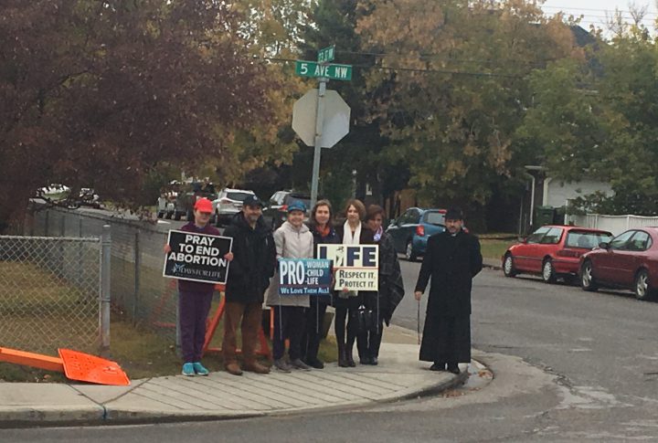 Members of 40 Days for Life gather on 5th Avenue N.W. near Kensington Clinic on Saturday.