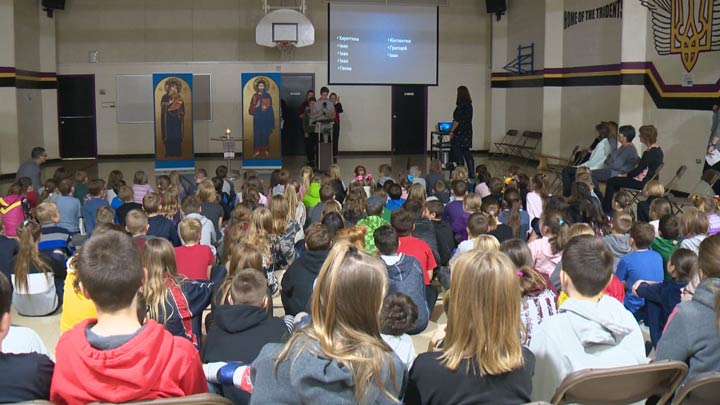 Students at Bishop Filevich Ukrainian Bilingual School lit a candle of remembrance Monday morning in memory of the millions of lives lost.