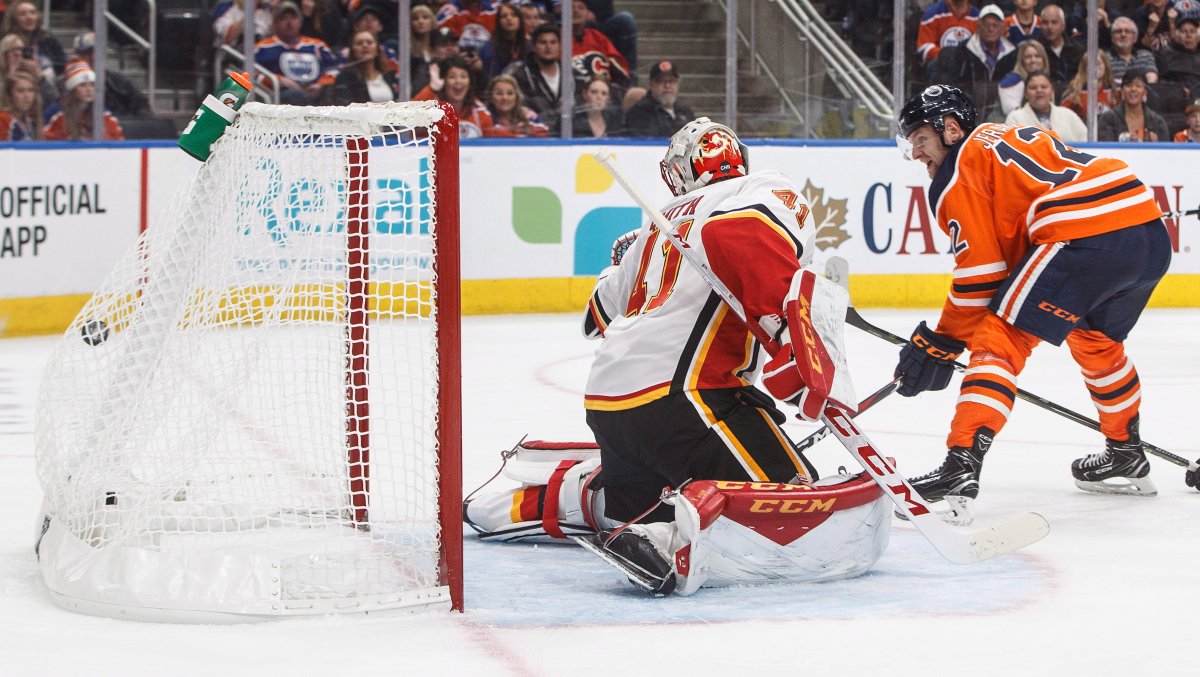 Flames ' goalie Mike Smith (41) is scored on as the Oilers' Jakub Jerabek (12) screens during NHL pre-season action in Edmonton on Saturday Sept. 29, 2018. 