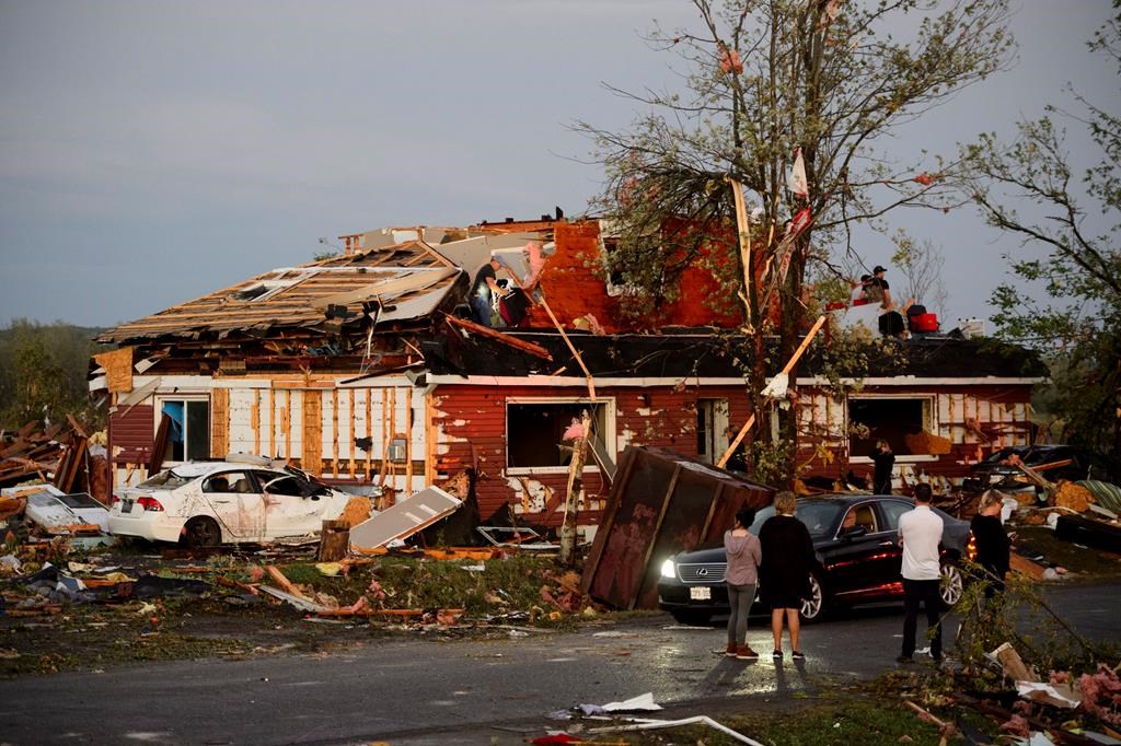 People collect personal effects from damaged homes following a tornado in Dunrobin, Ontario west of Ottawa on Friday, Sept. 21, 2018. THE CANADIAN PRESS/Sean Kilpatrick