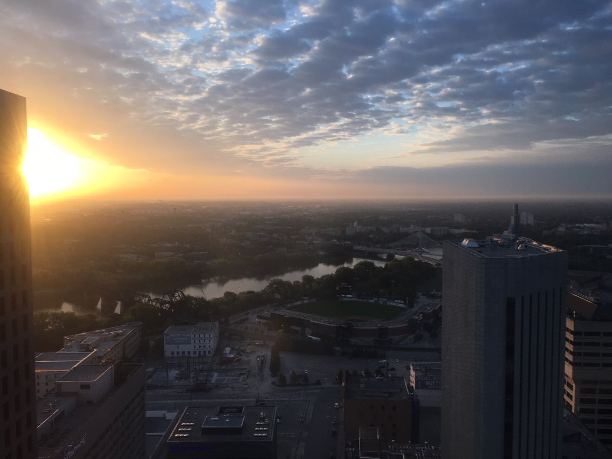 The sunrise over the city is accompanied by wildfire smoke Friday morning.