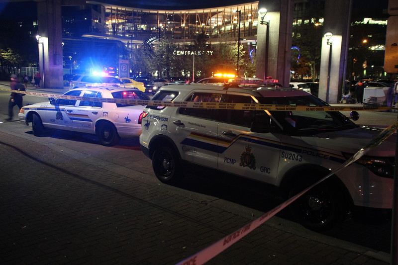 Police investigate a reported stabbing near the Surrey Central SkyTrain station on Wednesday night. 