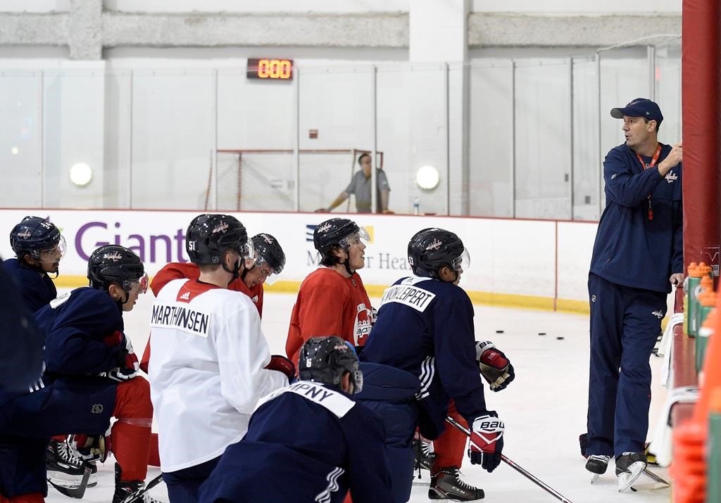 Washington Capitals head coach Todd Reirden, right, speaks to his players during NHL hockey training camp, Friday, Sept. 14, 2018, in Arlington, Va. (AP Photo/Nick Wass).
