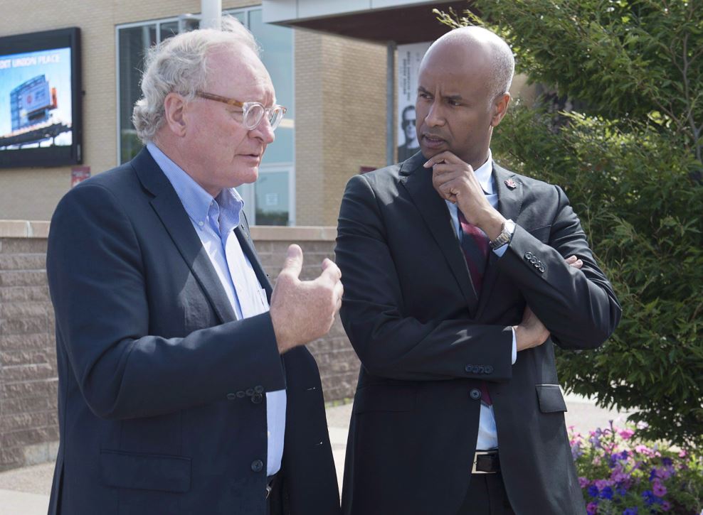 P.E.I. Premier Wade MacLauchlan, left, chats with Immigration Minister Ahmed Hussen at a meeting of the Atlantic Growth Strategy Leadership Committee in Summerside, P.E.I., on July 10, 2018. 