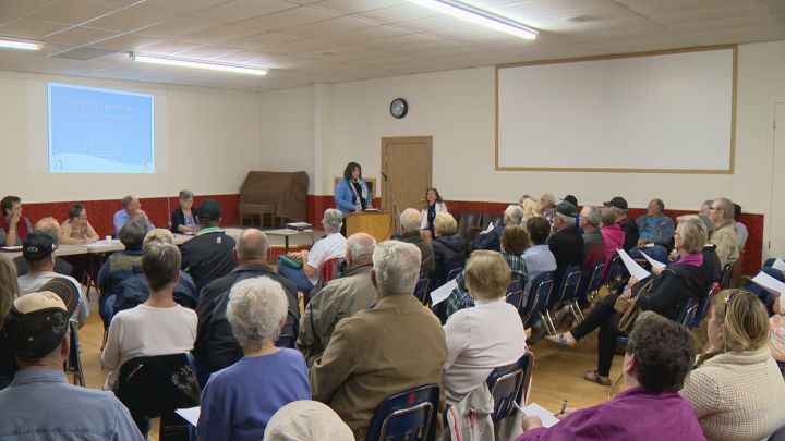 Area residents pack a community hall in Warner Wednesday night to listen to a municipal inspection report.