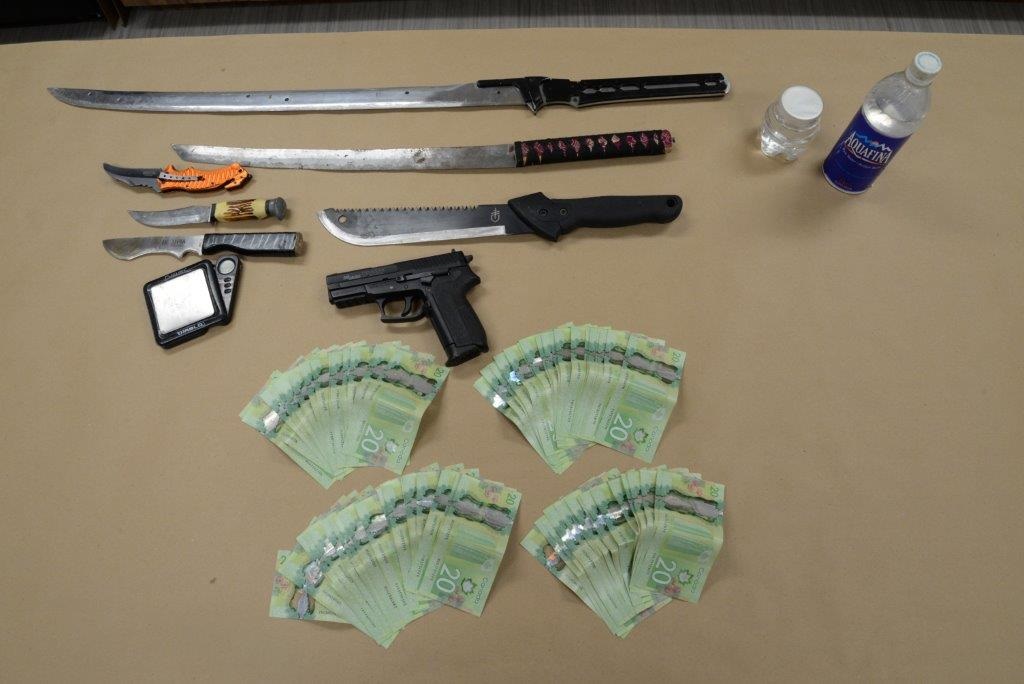 Police reportedly seized $1,920 in cash, a Rolex watch, cell phones, weigh scales, knives, a switch blade, and pellet gun.