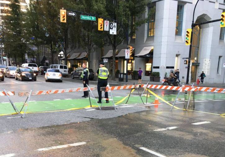 Police directing traffic at the site of a water main break in downtown Vancouver Wednesday morning.