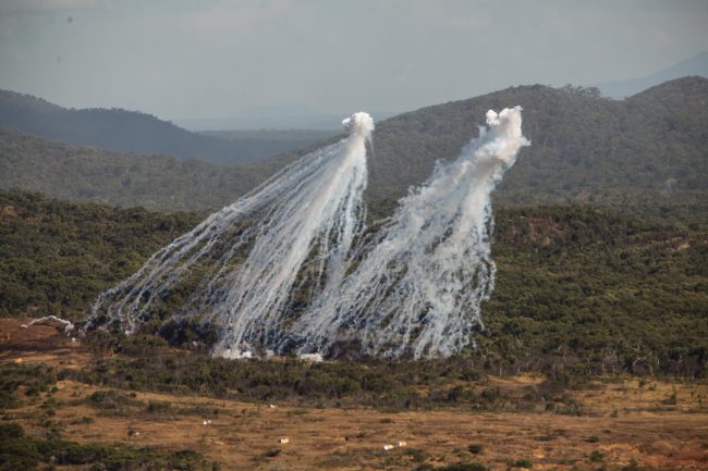 In this Aug. 3, 2013 file photo, white phosphorous streaks are seen during a U.S. Marine Corps live-fire exercise in Queensland, Australia.