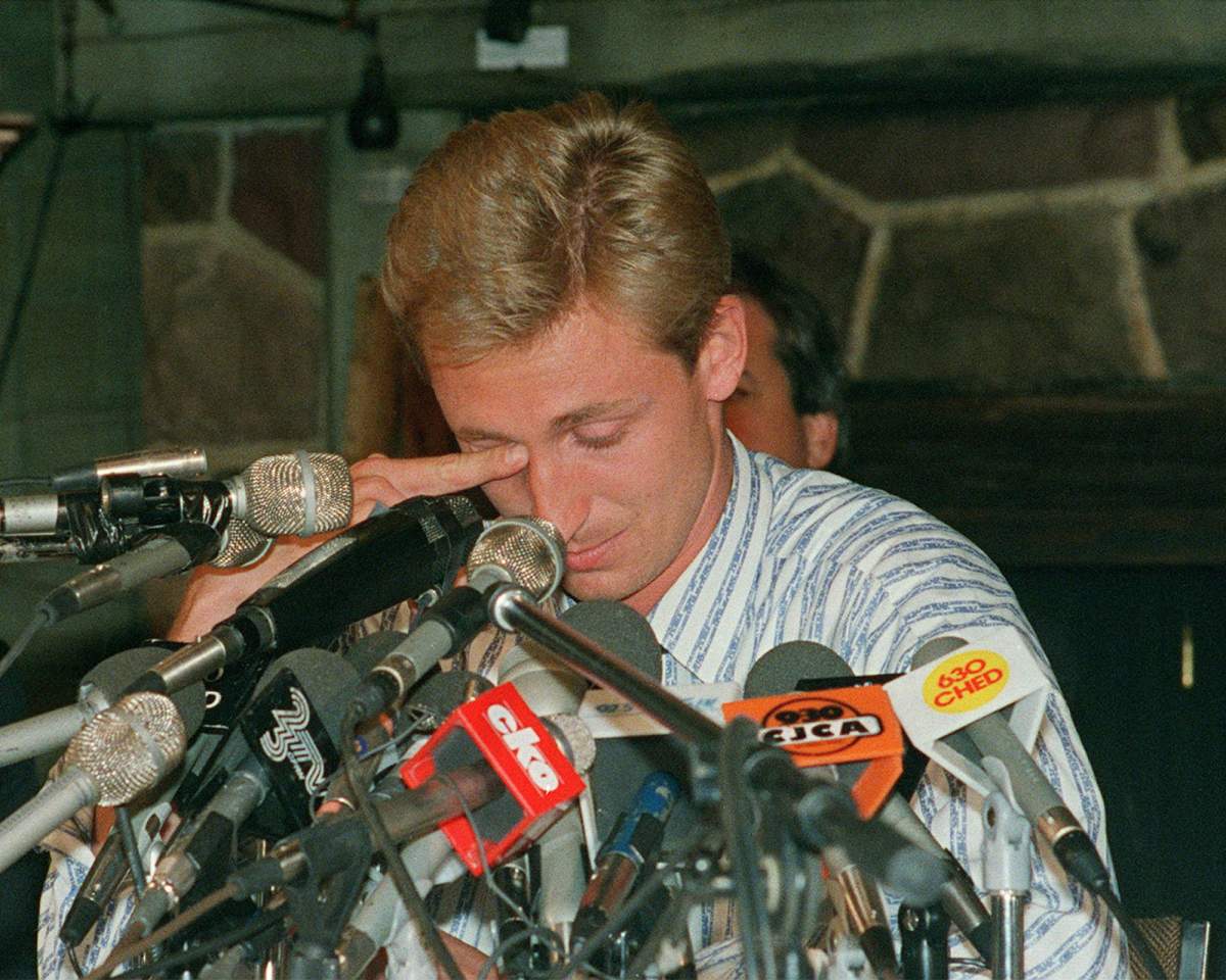 Wayne Gretzky wipes away tears during a press conference to announce his being traded from the Edmonton Oilers to the Los Angeles Kings at a press conference in Edmonton on August 9, 1988.