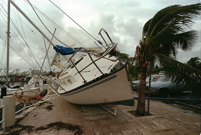 In this Aug. 24, 1992 file photo, a sailboat sits on a sidewalk at Dinner Key in Miami after it was washed ashore by Hurricane Andrew.