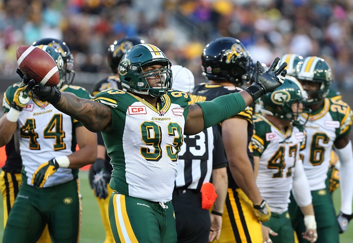 Edmonton Eskimos defensive tackle Don Oramasionwu (93) celebrates after gaining possession on a fumble by the Hamilton Tiger-Cats during the second half of CFL football action in Hamilton, Ontario on Saturday, September 19, 2015. 