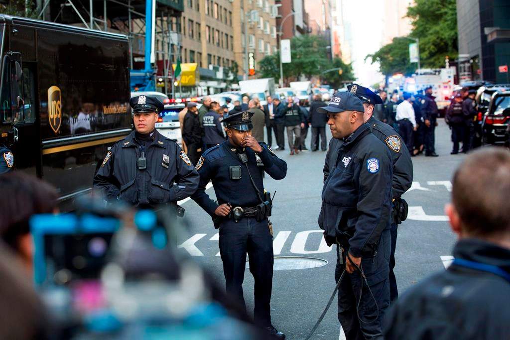 Officers watch over the scene outside the Time Warner Center on Wednesday, Oct. 24. Law enforcement officials say a suspicious package that prompted an evacuation of CNN's offices is believed to contain a pipe bomb.