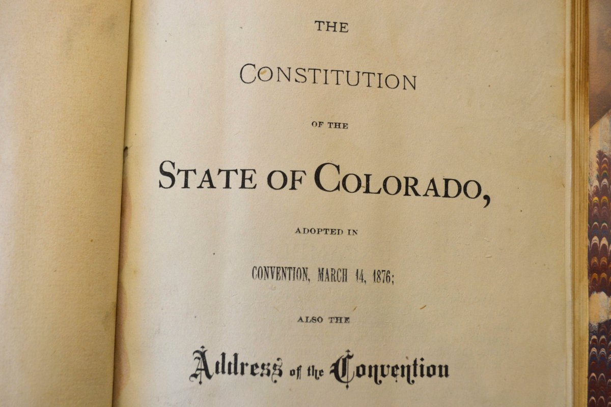 A close-up of an 1876 copy of the Colorado Constitution, which contains an exception under which slavery could be used as punishment for a crime.
