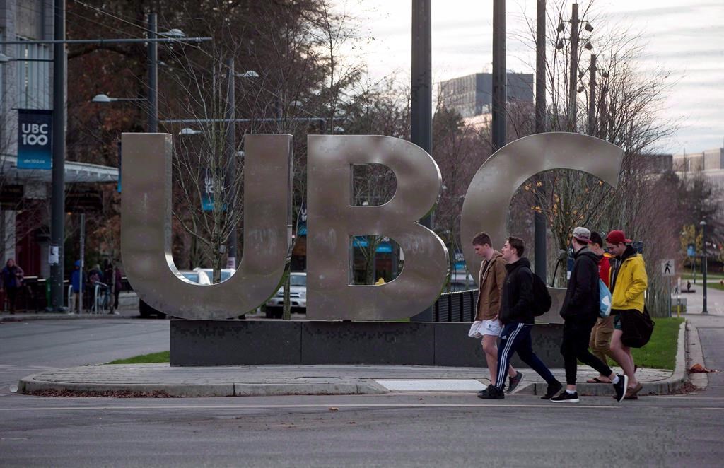 People walk past large letters spelling out UBC at the University of British Columbia in Vancouver, B.C., on Nov. 22, 2015.