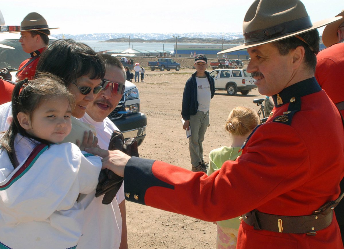 RCMP officer Paul Young talks to Iqaluit residents during Canada Day celebrations on Saturday July 1, 2006 in Iqaluit, Nunavut. Canada is celebrating the 139th anniversary of Confederation. 