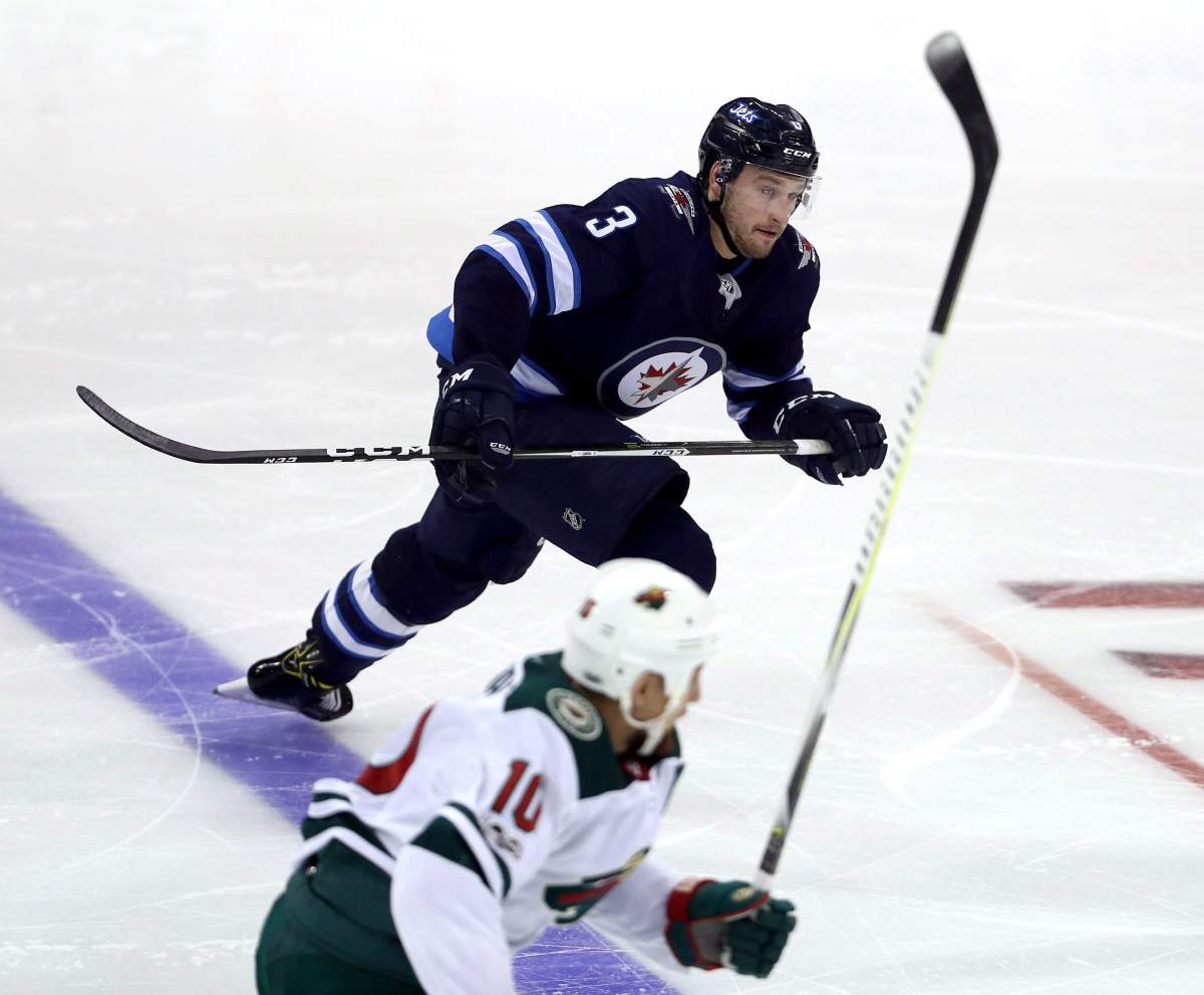 Winnipeg Jets defenceman Tucker Poolman (3) skates up ice while playing against the Minnesota Wild during third period NHL preseason hockey action in Winnipeg, Monday, September 18, 2017. THE CANADIAN PRESS/Trevor Hagan.