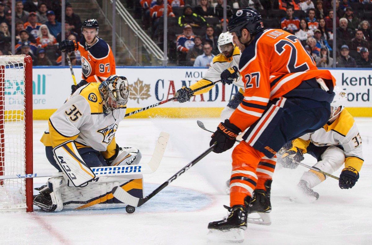 Nashville Predators' Pekka Rinne (35) makes the save on Edmonton Oilers' Milan Lucic (27) during second period NHL action in Edmonton, Alta., on Thursday March 1, 2018. THE CANADIAN PRESS/Jason Franson.