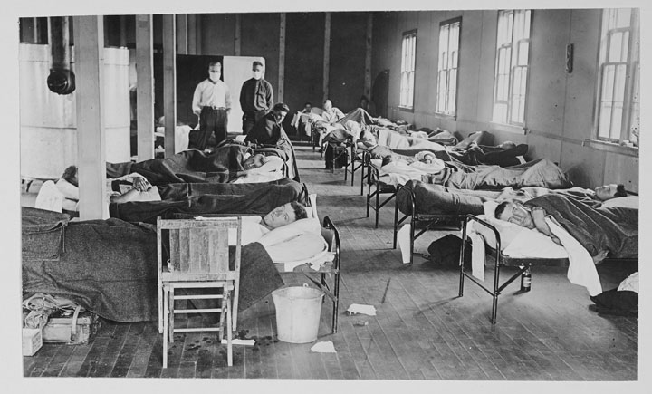 View of victims of the Spanish flu as they lie in beds at a barracks hospital on the campus of Colorado Agricultural College, Fort Collins, Colorado, 1918.