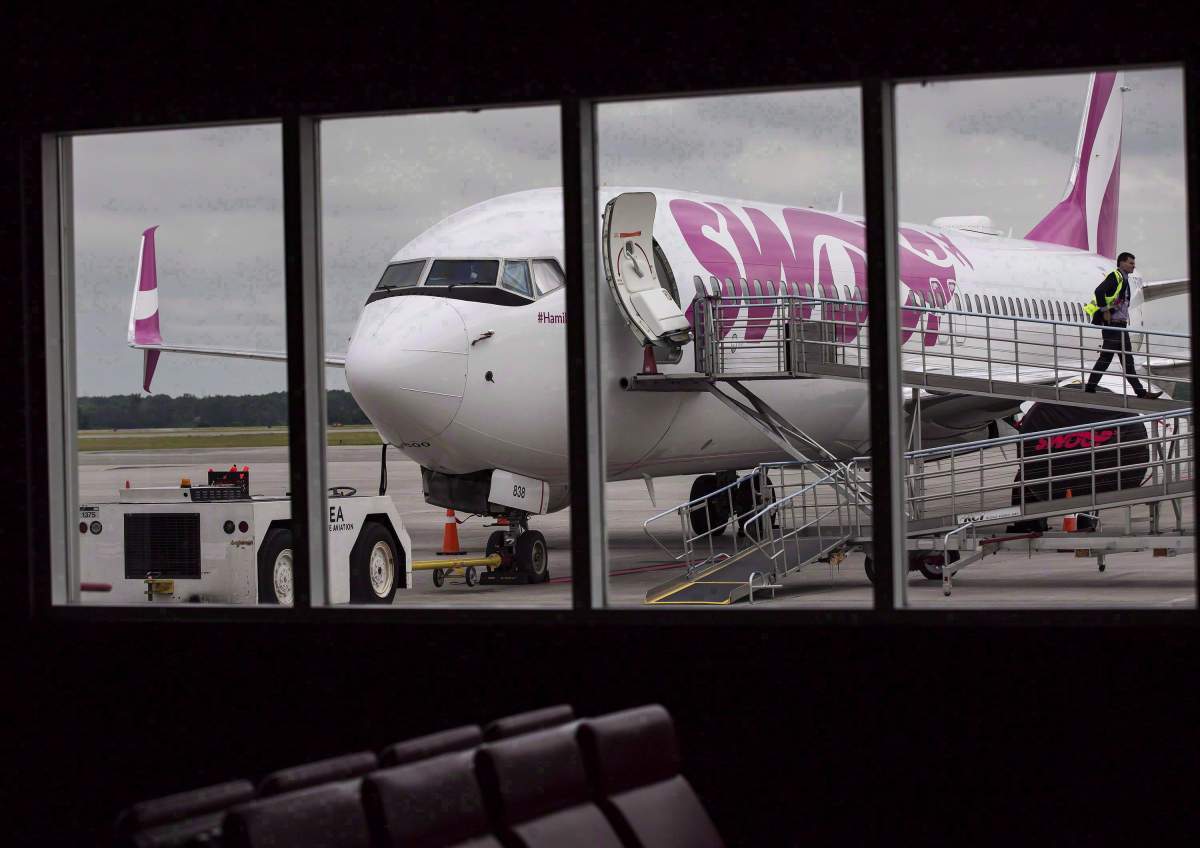 A Swoop Airlines Boeing 737-800 is on display during a media event, June 19, 2018 at John C. Munro International Airport in Hamilton, Ont. 