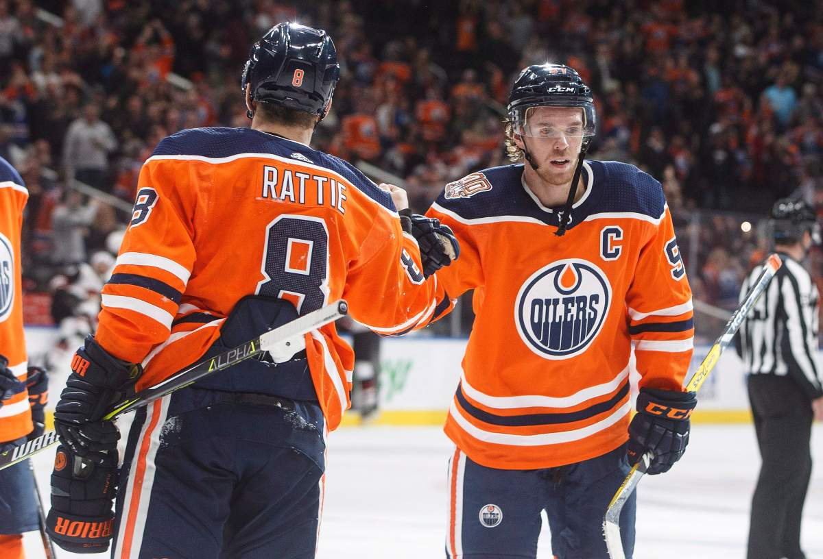 Edmonton Oilers’ Connor McDavid (97) and Ty Rattie (8) celebrate the overtime win against the Arizona Coyotes during preseason action in Edmonton on Thursday September 27, 2018.