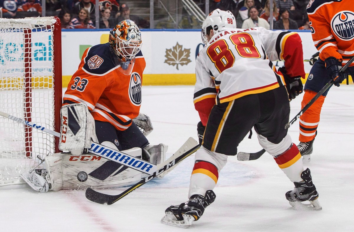 Calgary Flames ' Andrew Mangiapane (88) is stopped by Edmonton Oilers' goalie Cam Talbot (33) during first period NHL preseason action in Edmonton, Alta., on Saturday September 29, 2018. THE CANADIAN PRESS/Jason Franson.