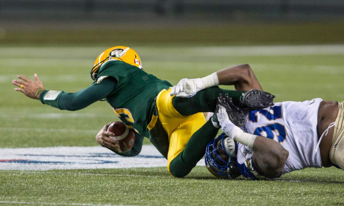 Winnipeg Blue Bombers' Drake Nevis (92) sacks Edmonton Eskimos quarterback Mike Reilly (13) during second half CFL action in Edmonton, Alta., on Saturday September 29, 2018. 